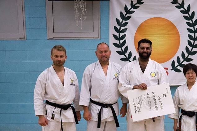 Sensei Shyam being presented his Special Hand Written 5th Dan Certificate by Sensei Alan Campbell, Head of JKS England and Sensei Okamoto JKS Headquarters Instructor and JKS World Champion.